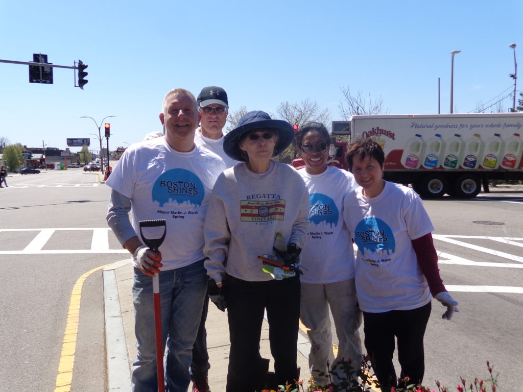 Bill Gleason (left) from the West Broadway Neighborhood Association is pictured on Dorchester Avenue near Broadway station with Boston Shines volunteers. (Photo by Kevin Devlin)