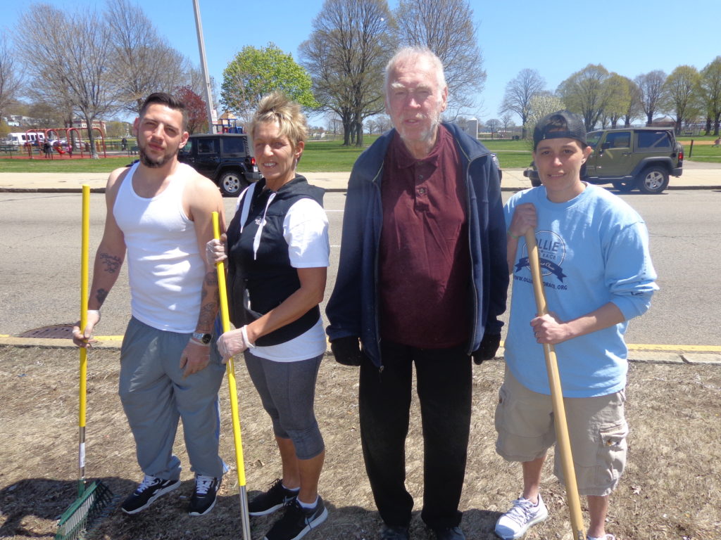 Devine Center volunteer coordinator Kathy Curley is pictured with Boston Shines volunteers on the greenery across from the Mary Ellen McCormack Housing Development. (Photo by Kevin Devlin)